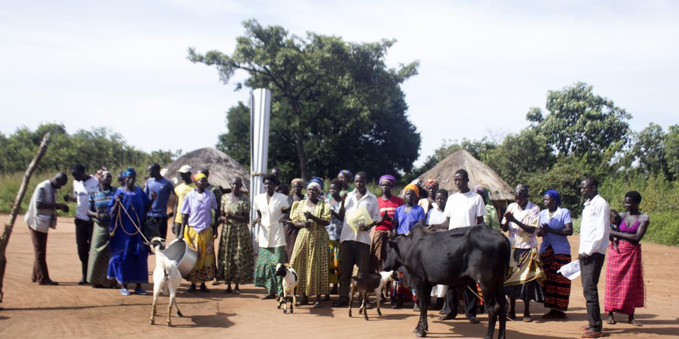 Members of Gen Badi Farmers group and the cow they bought from a few of their savings. Photo credit: Oxfam
